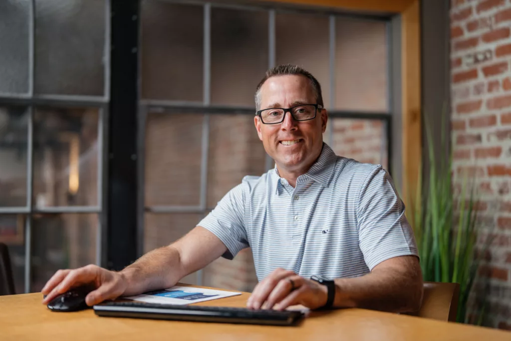 Dave Bartoski using keyboard and mouse smiling